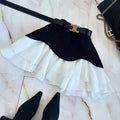 Beige two tone ruffled high waist tiered skirt with black belt and gold tone c shaped buckle in black and white