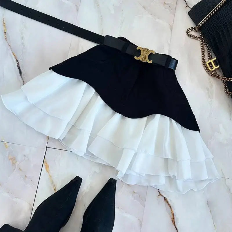 Beige two tone ruffled high waist tiered skirt with black belt and gold tone c shaped buckle in black and white