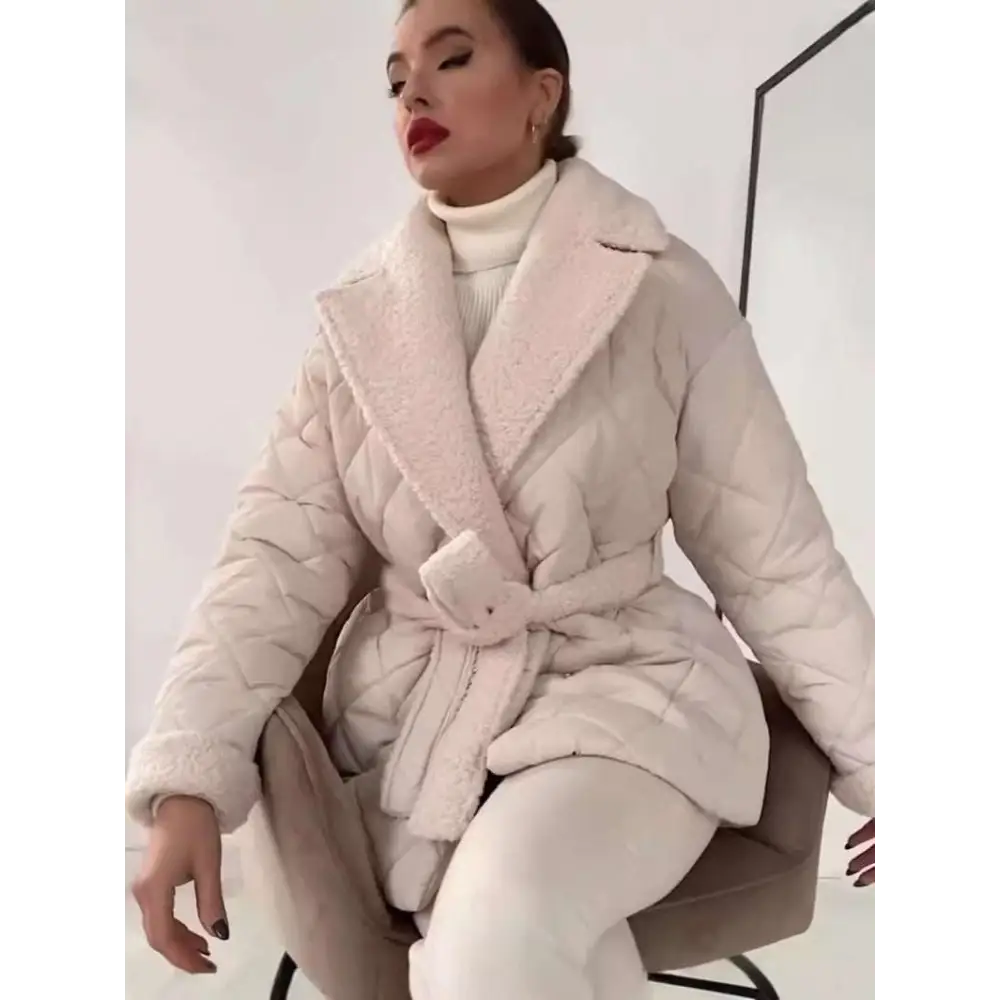 A cozy blush-pink quilted design coat with plush shearling collar and matching belt in beige winter lapel style