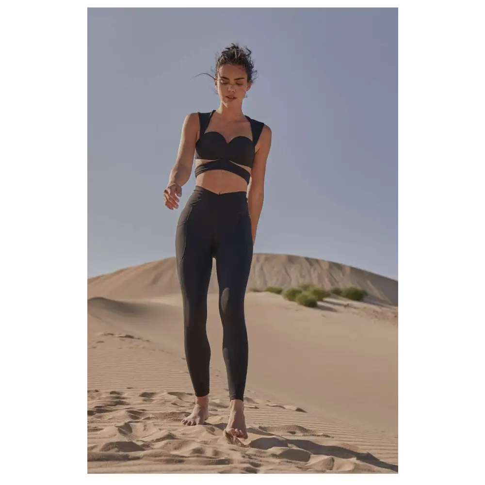 Black athletic two-piece set with cropped bra top and seamless leggings contrasting beige yoga pants sport coat fitness set