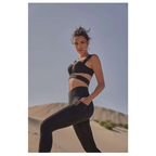 Black athletic two-piece set with sleek cut-out design complementing beige yoga pants and sport coat fitness set