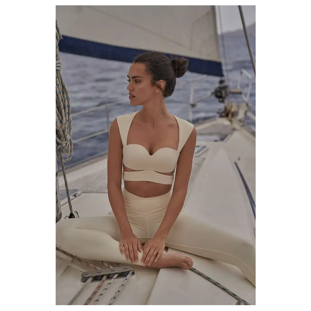 Beige yoga pants and cream-colored form-fitting sport coat fitness set with sweetheart neckline and cut-out details