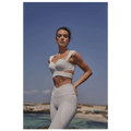 White athletic two-piece set with sleek form-fitting design and subtle seam detailing for sport coat fitness use