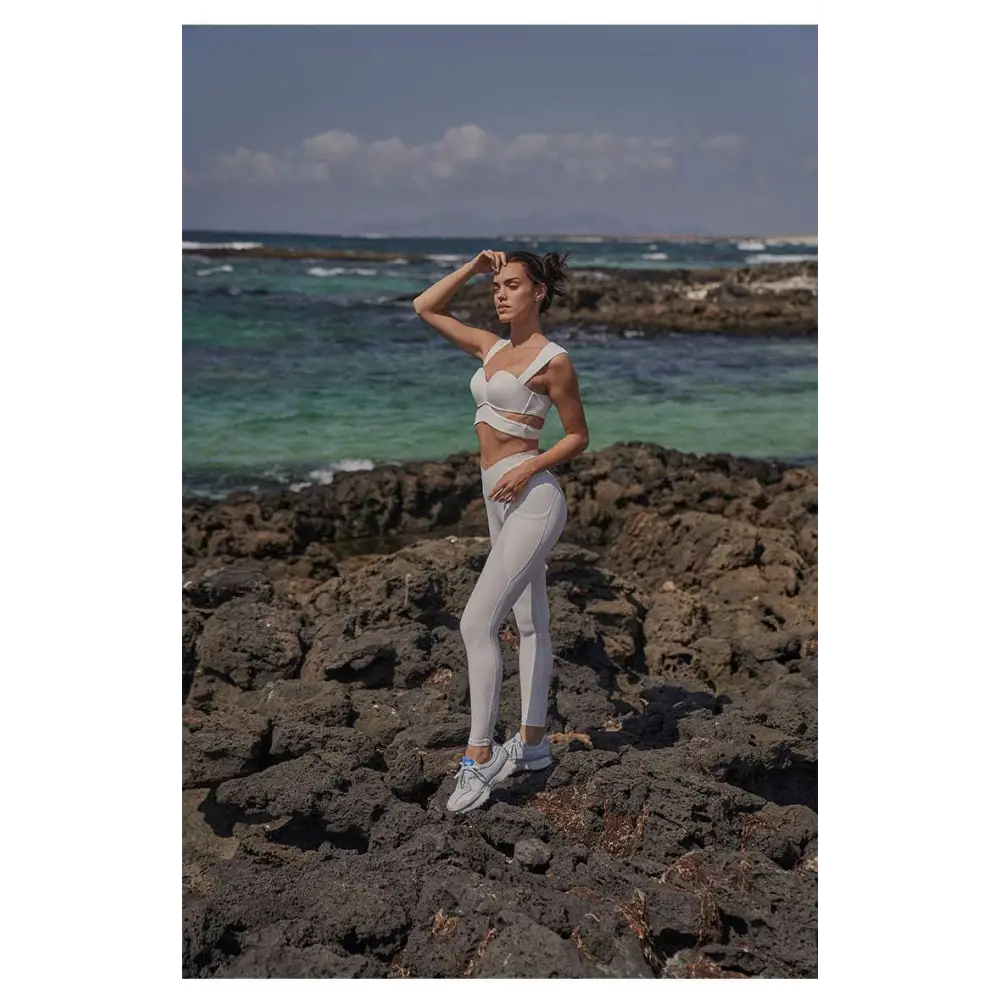 White athletic two-piece set with cut-out design and seamless leggings paired with beige yoga pants and sport coat fitness set
