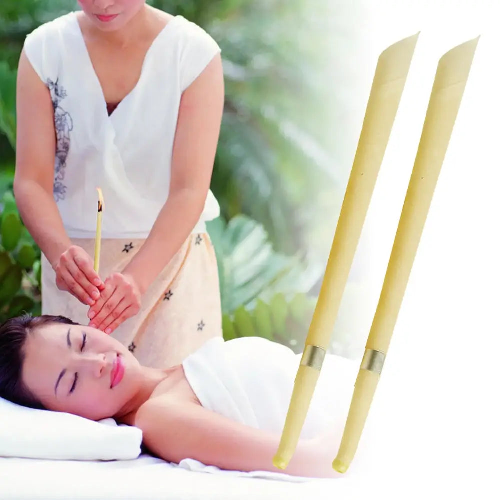 Two slender pale yellow bamboo acupuncture needles with metallic silver bands near their bases for coning beewax natural ear candle ear healthy care and wax removal.