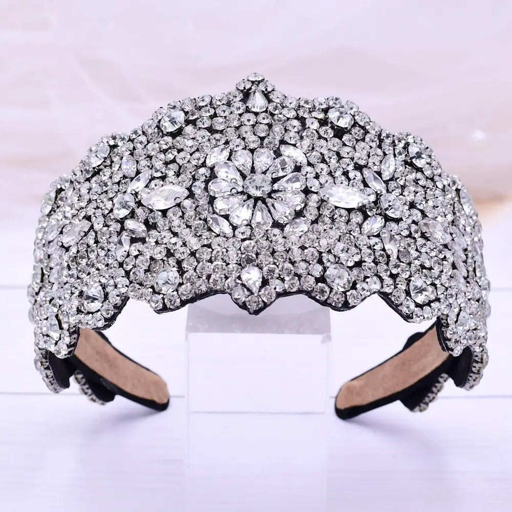 A sparkling silver rhinestone fashion retro headband featuring a floral design with scalloped edges.