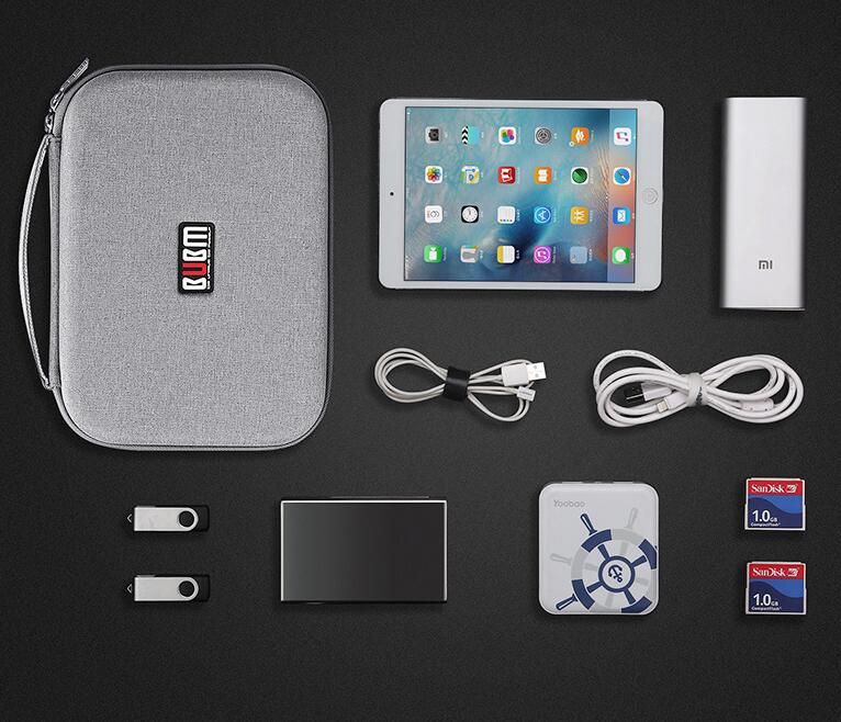 gray textured digital storage bag with black and white logo designed as a qucm tablet case for organized travel storage