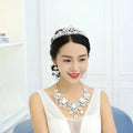 A sparkling silver tiara with intricate crystal details and an ornate design perfect for big crystal bridal wear
