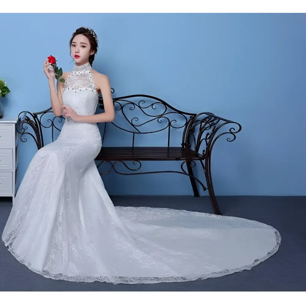 White lace mermaid wedding gown with high neckline and beaded embellishments showcasing size waist details