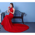 A woman wears a vibrant red lace mermaid gown with high neck and elegant train perfect for big red wedding dress size waist