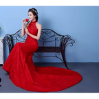 A woman wears a vibrant red lace mermaid gown with high neck and elegant train perfect for big red wedding dress size waist