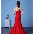 Vibrant red lace mermaid gown with strapless back and intricate corset-style lacing highlighting size waist features