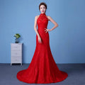 A vibrant red lace mermaid wedding dress with a high neckline and intricate floral embroidery showcasing size waist details