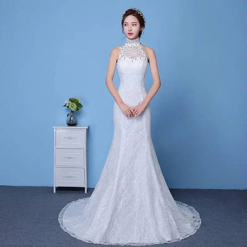 White lace mermaid wedding gown with high neckline and beaded detailing featuring size waist accents