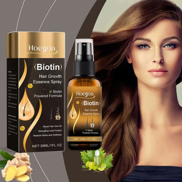 Hoegoa biotin hair growth essence spray in an amber glass bottle with black spray nozzle next to gold and black packaging