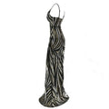 Black and silver sequined mermaid evening dress with fitted silhouette, thin straps, and elegant flowing skirt