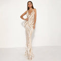 A shimmering champagne-colored silver sequined mermaid evening dress with plunging v-neckline and slit-leg design