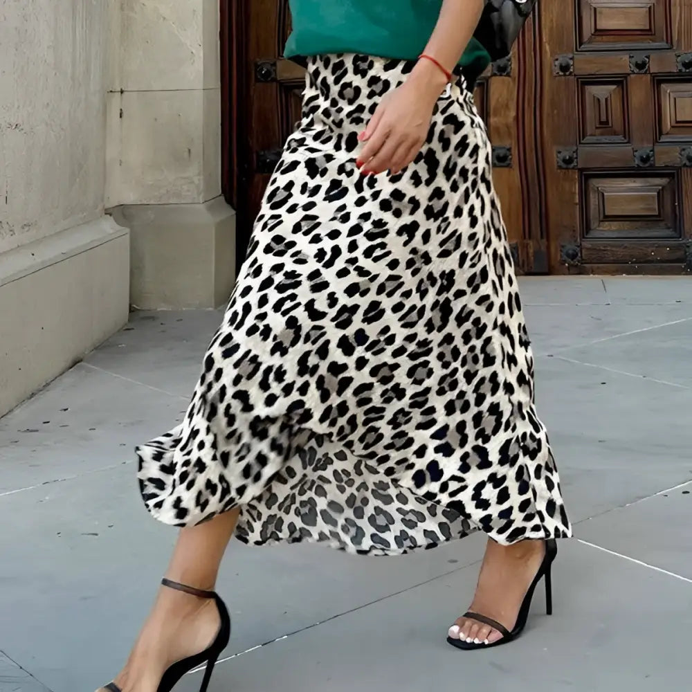 A black and white leopard print elastic a line skirt with lightweight fabric and a flowing flared hem