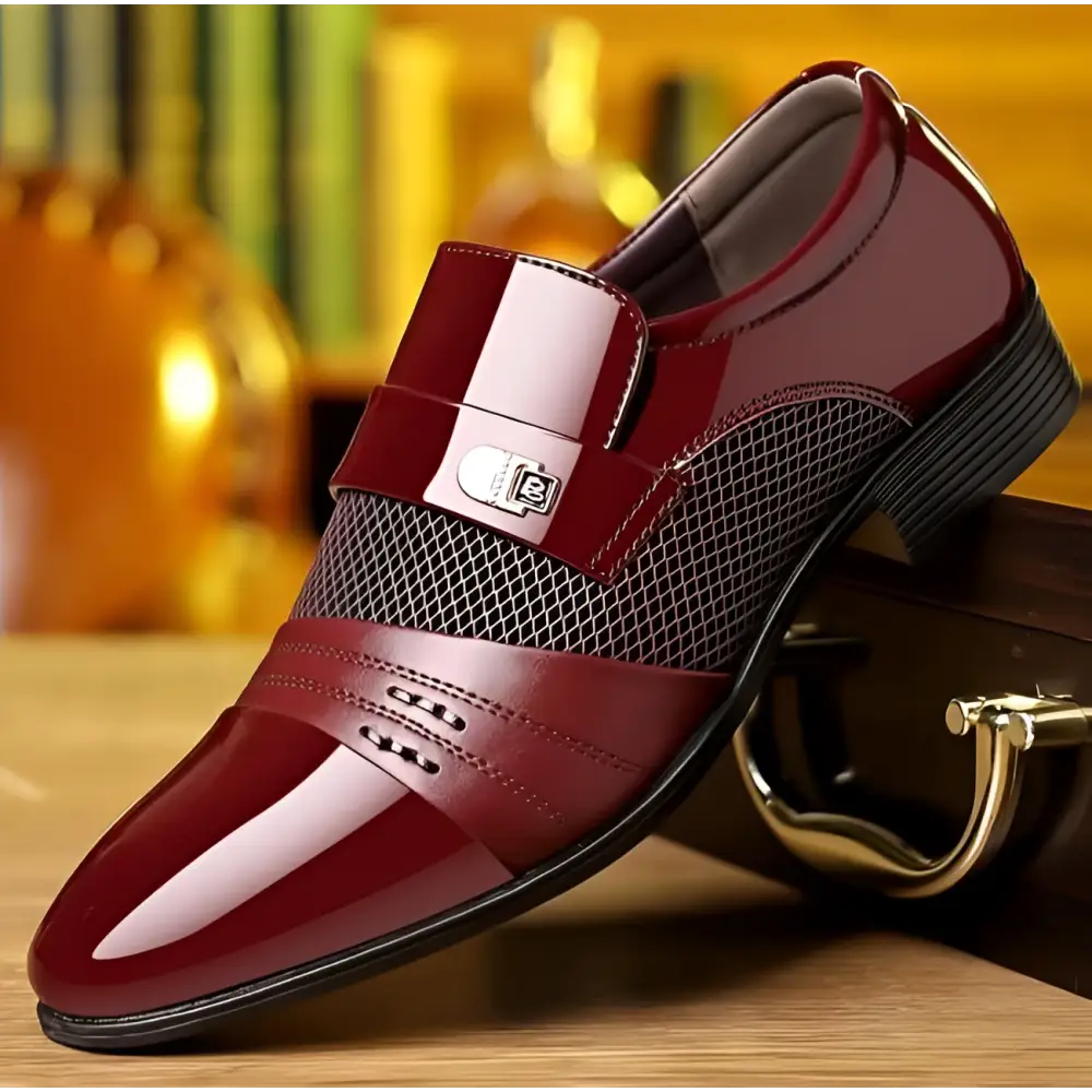Polished burgundy patent leather shoes featuring white mesh panel and silver buckle for formal occasions