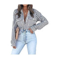 Black and white vertical stripe shirt with long sleeves and chest pockets in luxury women’s fashion design