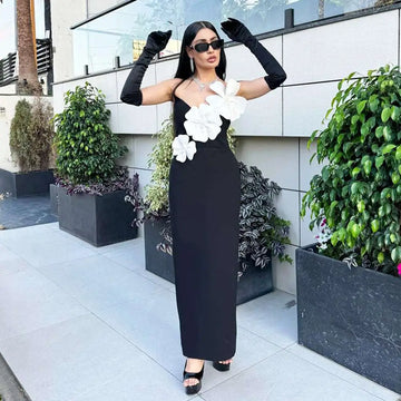 Black backless bandage gown featuring a strapless bandage chest with large white floral appliqués detailing