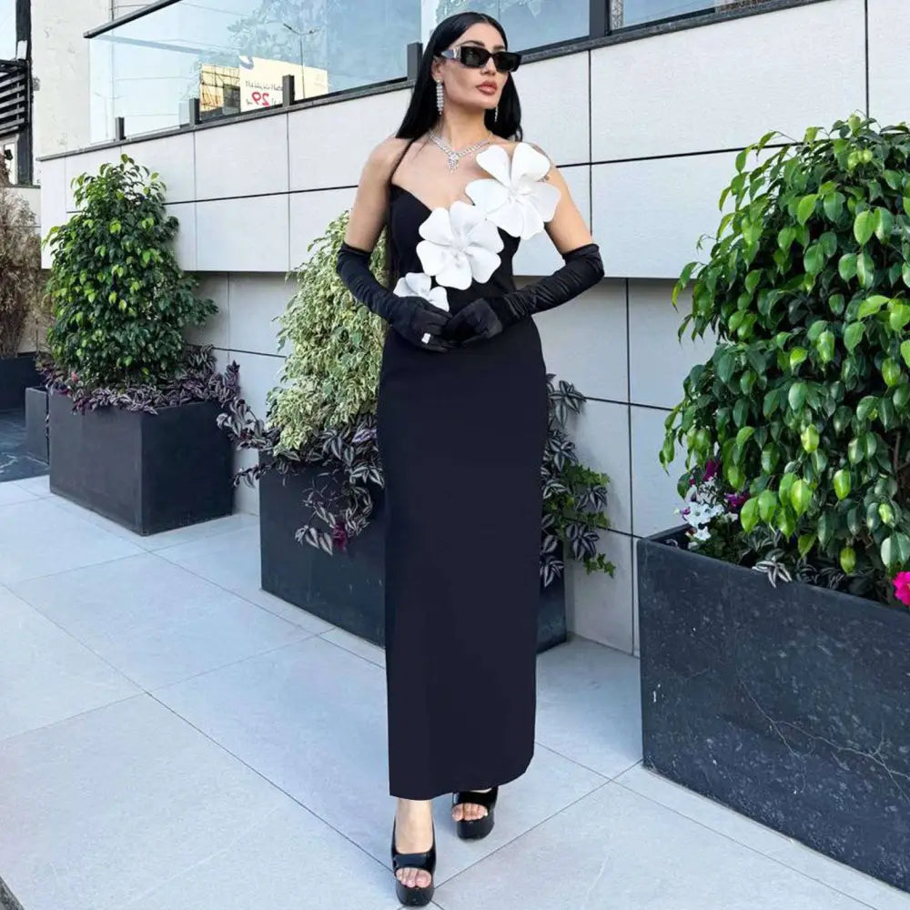 Black backless bandage gown featuring a strapless bandage chest with large white floral appliqués detailing