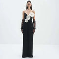 Black backless bandage gown featuring white floral appliqués and sheer black lace gloves with a bandage chest white design