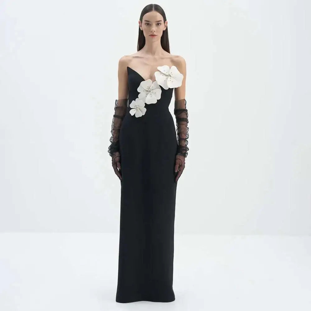 Black backless bandage gown featuring white floral appliqués and sheer black lace gloves with a bandage chest white design