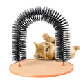 Black bristle grooming cat toy arch with orange scratch pad base and a ginger kitten peeking through