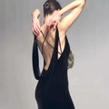 Back view of black camisole backless slim velvet floral gown featuring deep cutout and crisscross straps