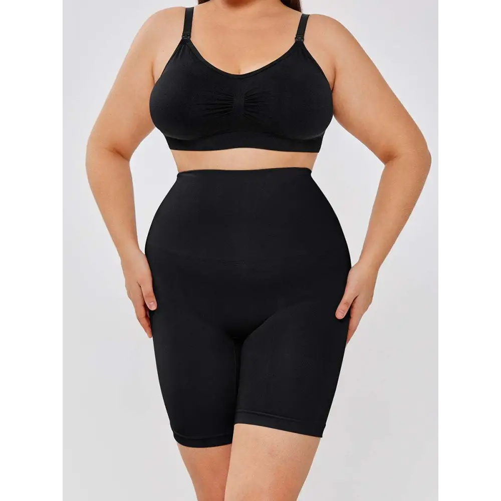 Black casual slim leggings shapewear set with supportive bra top and two-layer shaper shorts in seamless fabric