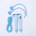 Light blue cordless electronic skipping rope with spherical handles and coiled cord for skipping rope workouts
