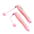 Pink cordless electronic skipping rope with textured grip spherical handles and digital display for skipping rope workouts