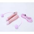 Black cordless electronic skipping rope with pink digital jump rope handles and soft lavender spherical ends for workouts