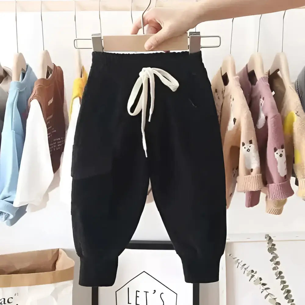 Black corduroy cotton cargo pants for boys featuring a white drawstring waistband and comfortable jogger style