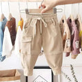 Black corduroy cotton cargo pants for boys with elastic waistband, drawstring, large side pockets, and cuffed ankles in beige