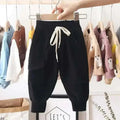Black corduroy cotton cargo pants for boys with white drawstring and side pockets in black corduroy cotton fabric