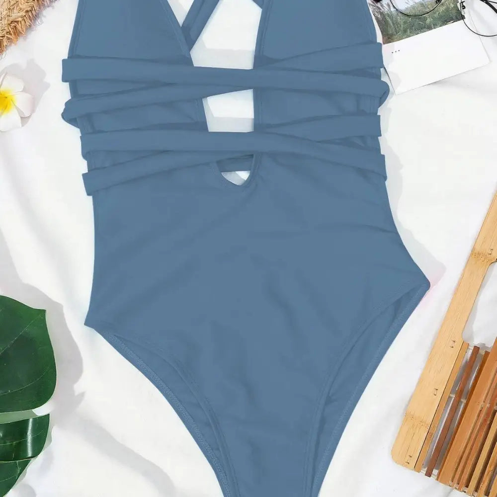 A sleek solid blue one-piece fashion pure color swimsuit with deep v neck and crossed strap cutout design