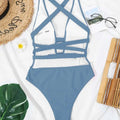 A stylish blue one-piece color bikini swimsuit with deep v neck and white mesh panels featuring a crisscross back design