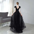 Elegant black double shoulder evening dress featuring feathered shoulder accents and a sparkling sequined bodice
