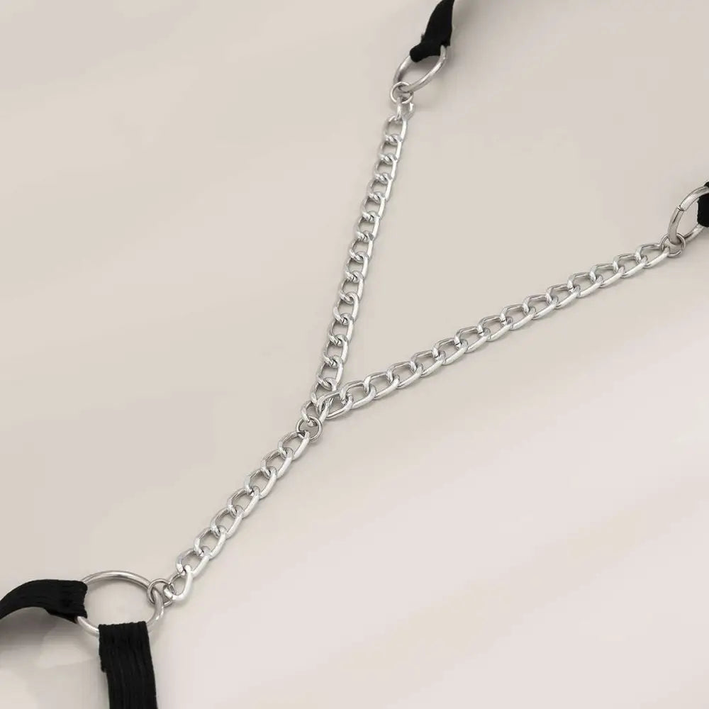 Black elastic geometric body chain thigh garter with silver-toned metal chain and black fabric straps in y-shaped design