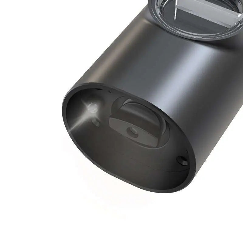Black cylindrical electric kitchen household grinder housing with matte finish and visible internal components
