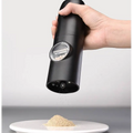 Black electric kitchen household grinder set with clear window revealing peppercorns inside for precise grinding