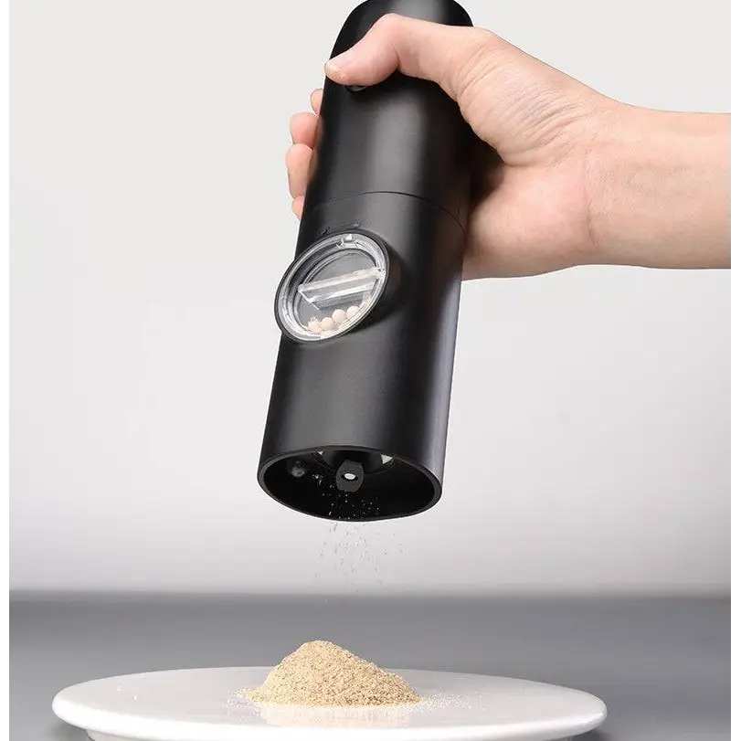 Black electric kitchen household grinder set with clear window revealing peppercorns inside for precise grinding