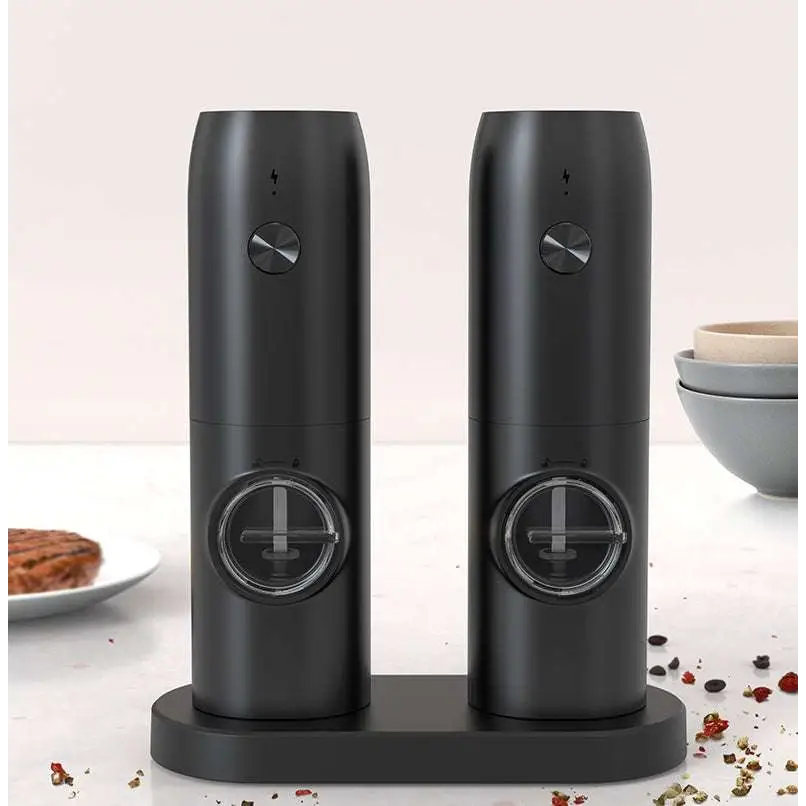 Black electric kitchen household grinder set with sleek cylindrical design metallic knobs and transparent windows