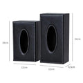 Black faux leather car tissue box cover with white stitching and oval cutout for easy tissue access