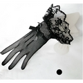 Black fishnet stretch mesh gloves with intricate lace cuffs and decorative bow in knitted stretch mesh material