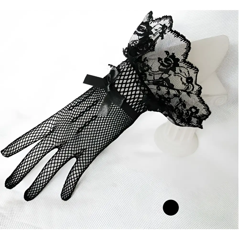 Black fishnet stretch mesh gloves with intricate lace cuffs and decorative bow in knitted stretch mesh material