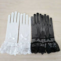 A pair knitted stretch mesh gloves in black and white with lace cuffs and matching bows at the wrist
