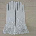 White stretch mesh gloves with lace cuffs featuring delicate bows and ruffled trim in a pair knitted stretch design
